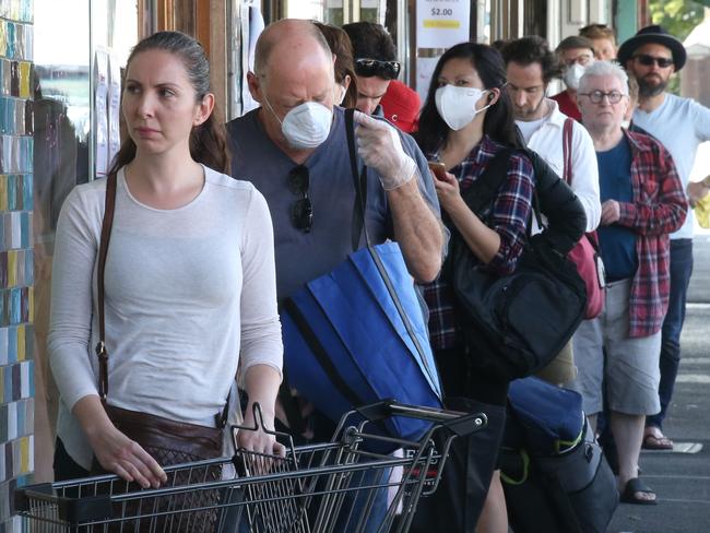 Local Coronavirus Impact 3 North. Corona Virus images in Northcote  People queue for an organic fruit and veg store.  on High street in Northcote. Friday, April 3, 2020. Picture: David Crosling