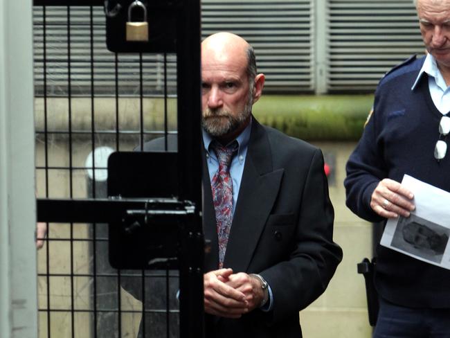 Peter Joseph Kelly being led into a prison van at the rear of King Street Supreme Court.