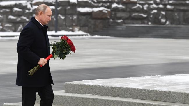 Vladimir Putin delivers a floral tribute at the headquarters of the Foreign Intelligence Service in Moscow on Sunday. Picture: AFP