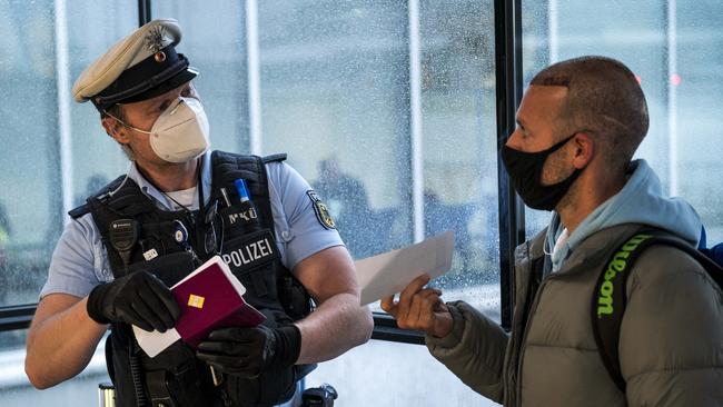 Border police check passengers arriving on a flight from Spain to be sure they can show evidence of a recent COVID-19 test at Frankfurt Airport in Frankfurt, Germany. Picture: Getty Images