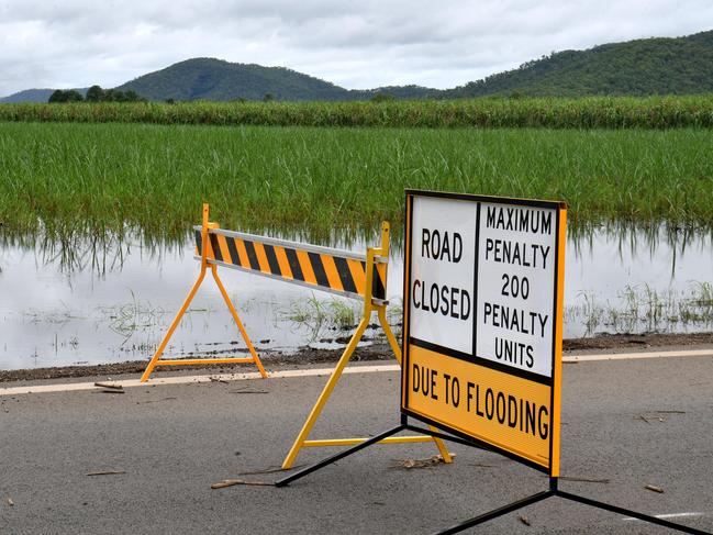 Flood warning signs on Woodstock-Giru Rd near Townsville. Picture: Evan Morgan