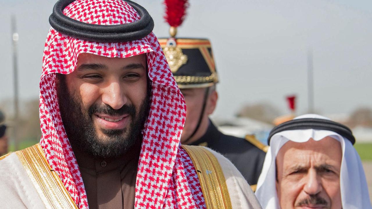 CORRECTION - Saudi Arabia's crown prince Prince Mohammed bin Salman (L) arrives at Le Bourget airport, north of Paris, on April 8, 2018, ahead of a state visit. Saudi Arabia's crown prince Prince Mohammed bin Salman arrived in France on April 8, for the next leg of a global tour aimed at reshaping his kingdom's austere image as he pursues his drive to reform the conservative petrostate. / AFP PHOTO / Saudi Royal Palace / BANDAR AL-JALOUD / RESTRICTED TO EDITORIAL USE - MANDATORY CREDIT "AFP PHOTO / SAUDI ROYAL PALACE / BANDAR AL-JALOUD" - NO MARKETING - NO ADVERTISING CAMPAIGNS - DISTRIBUTED AS A SERVICE TO CLIENTS / “The erroneous mention[s] appearing in the metadata of this handout photo by the Saudi Royal Palace has been modified in AFP systems in the following manner: [Saudi Royal Palace] instead of [Ahmed Nureldine]. Please immediately remove the erroneous mention[s] from all your online services and delete it (them) from your servers. If you have been authorized by AFP to distribute it (them) to third parties, please ensure that the same actions are carried out by them. Failure to promptly comply with these instructions will entail liability on your part for any continued or post notification usage. Therefore we thank you very much for all your attention and prompt action. We are sorry for the inconvenience this notification may cause and remain at your disposal for any further information you may require.”