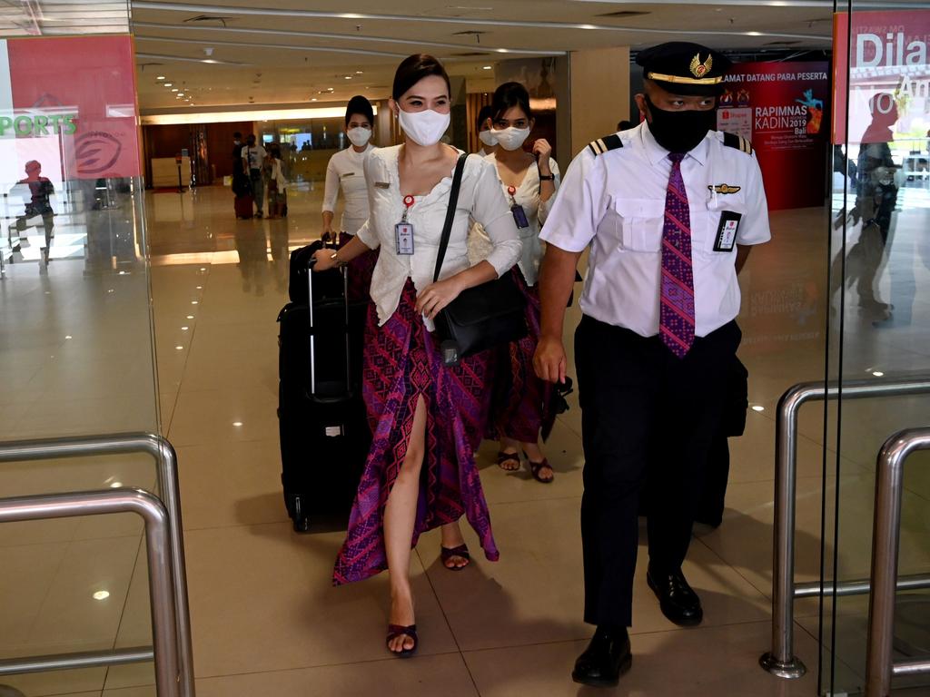 Crew members arrive at Ngurah Rai International Airport. Picture: AFP