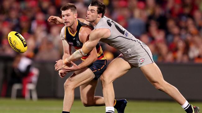 Crows recruit Bryce Gibbs under pressure from former Carlton teammate Lachie Plowman. Picture: James Elsby/AFL Media/Getty Images)