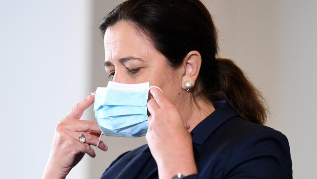 Queensland Premier Annastacia Palaszczuk puts her face mask on during a press conference to provide a COVID-19 update. Picture: NCA NewsWire / Dan Peled