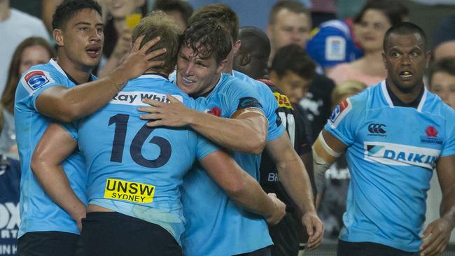 The Waratahs celebrate Ned Hanigan’s winning try on Saturday night.