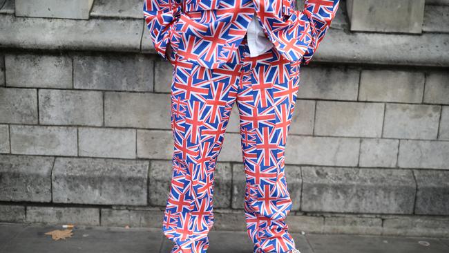 A man is dressed in a suit covered in Union Jack flags outside the Palace of Westminster. Picture: Getty Images.