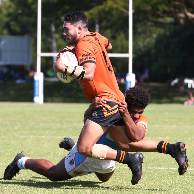 Tully's Michael Carroll is cleaned up by Sami Raivaroro in the Round 2 match of the Lightning Challenge between the Northern Pride Reef Kings and the Tully Tigers, held at Stan Williams Park. PICTURE: BRENDAN RADKE