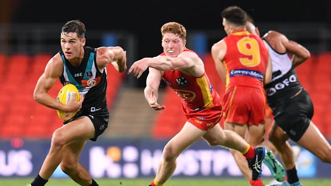 Connor Rozee (left) of the Power gets past Matthew Rowell. Picture: AAP Image/Darren England.