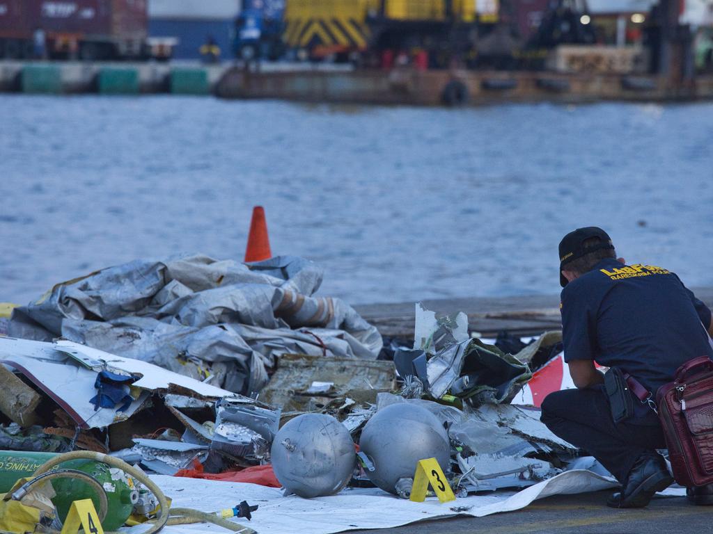 A forensic investigator looks through the remains of the doomed flight. Picture: Ed Wray/Getty Images