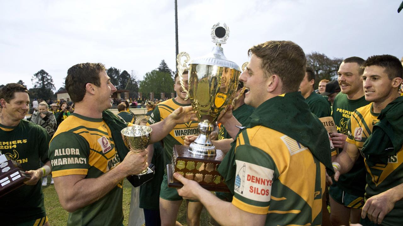 Wattles players celebrate winning the 2014 grand final.