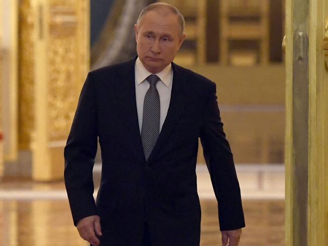 Russian President Vladimir Putin enters a hall to attend a meeting with graduates of the country's higher military schools at the Kremlin in Moscow on June 21, 2022.