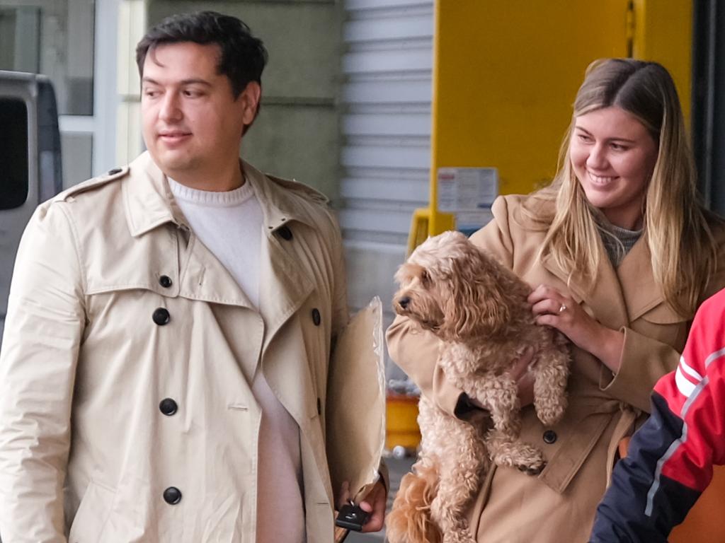 Brittany Higgins and David Sharaz cuddle their cavoodle dog Kingston and carry their cat Clover after the animals cleared quarantine at the Bordeaux-Merignac airport in France n December, 2023. Picture: Jacquelin Magnay