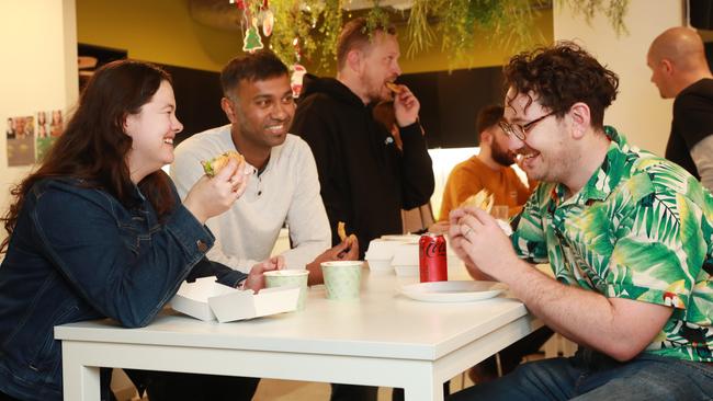 Finder employees in Sydney, Elise Stitt, Raj Lal and Tim Bennett, enjoy a free lunch as part of an effort to get them into the office. Picture: John Feder