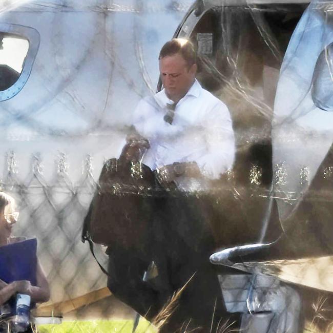 Premier Steven Miles and staff exit a private jet, VH-VKX, at the Government Air Wing, Brisbane Airport. Picture: Lyndon Mechielsen