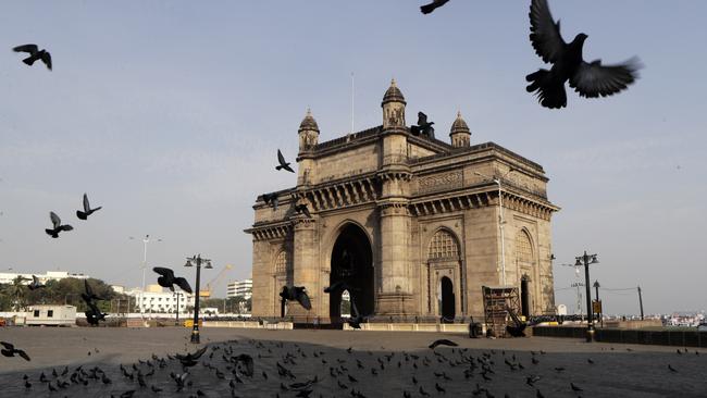 Pigeons fly at a deserted Gateway of India monument in Mumbai. Picture: AP