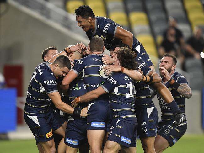 Heilum Luki is mobbed after scoring a try on debut. (Photo by Ian Hitchcock/Getty Images)