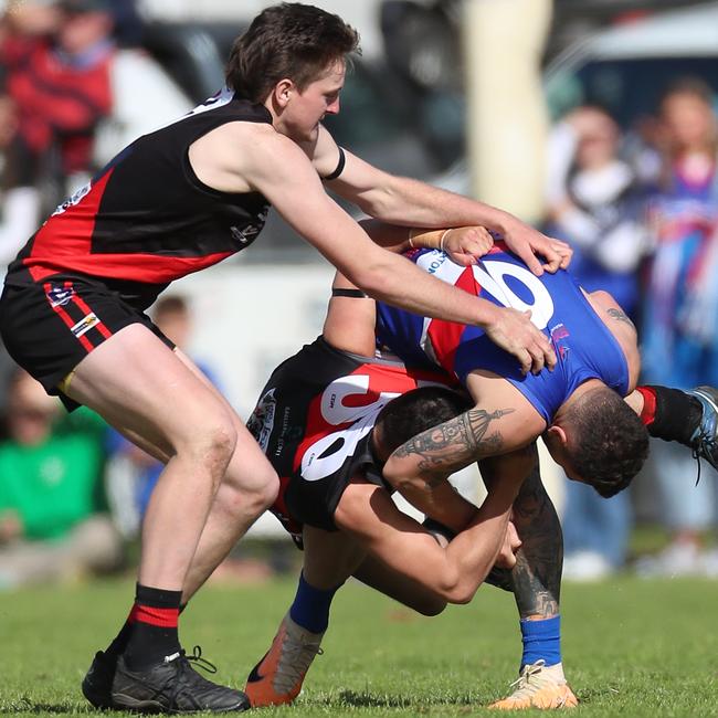 Waaia pair Ky Johnston and Shaun Greenway tangle with Strathmerton’s Darcy McCormack.