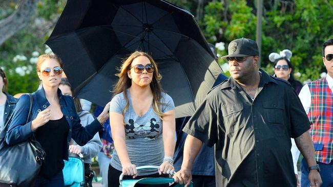 EXCLUSIVE: Mariah Carey spent the day at Disneyland and California Adventure with her two children Moroccan Cannon and Monroe Cannon at the happiest place on earth and brought along a very large entourage that included two nannies, four bodyguards, three disneyland VIP tour guides and a woman who acted as her umbrella carrier the entire day. The lady with the umbrella walked behind and around Mariah the entire day covering her from the sun. even as mariah rode rides this woman was always nearby. Mariah and her children enjoyed many rides throughout the day including toy story mania, a carousel, the dumbo ride, space mountain, the hollywood tower of terror and the star tours ride. Mariah also treated her children to a special lunch at Ariel's grotto where they were greeted by many of the characters fro the park including Ariel herself. Pictured: Mariah Carey, Monroe Cannon, and Moraccan Cannon Ref: SPL1031358 200515 EXCLUSIVE Picture by: Fern / Sharpshooter Images Splash News and Pictures Los Angeles: 310-821-2666 New York: 212-619-2666 London: 870-934-2666 photodesk@splashnews.com