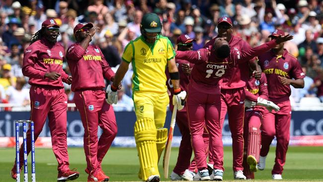 Usman Khawaja is downcast as he leaves the field after being dismissed by Sheldon Cottrell. Picture: AFP