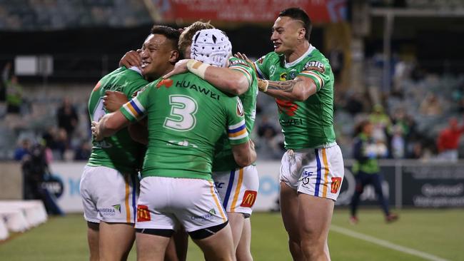 Jarrod Croker of the Raiders (No. 3) celebrates with teammates after scoring a try during the round 16 NRL match between the Canberra Raiders and the Canterbury Bulldogs at GIO Stadium.