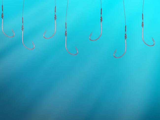 Many empty fish hooks hanging in deep blue water