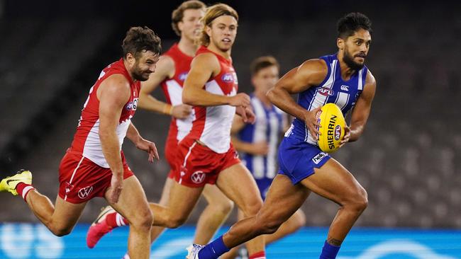 Aaron Hall of the Kangaroos runs with the ball from Harry Cunningham of the Swans during the Round 3 AFL match between the North Melbourne Kangaroos and the Sydney Swans at Marvel Stadium in Melbourne, Saturday, June 20, 2020. (AAP Image/Michael Dodge)