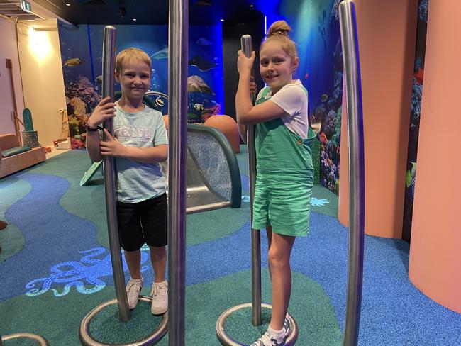 Rory, 6, and Kayla Downes, 10, and try out the interactive activity based equipment in Reef Play, the new play space in Willows Shopping Centre. Picture: Leighton Smith.