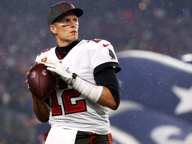 FILE - JANUARY 22, 2022: It was reported that NFL quarterback Tom Brady of the Tampa Bay Buccaneers is retiring from football after 22 seasons and seven Super Bowl titles January 29, 2022. FOXBOROUGH, MASSACHUSETTS - OCTOBER 03: Tom Brady #12 of the Tampa Bay Buccaneers warms up in front of the New England Patriots tunnel before the game between the Buccaneers and the Patriots at Gillette Stadium on October 03, 2021 in Foxborough, Massachusetts. (Photo by Maddie Meyer/Getty Images)