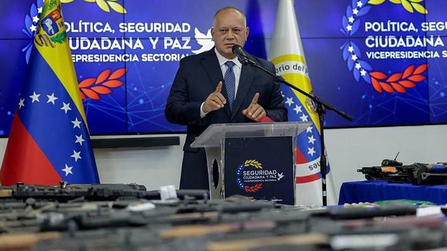 Interior Minister Diosdado Cabello displays the seized rifles. Picture: AFP