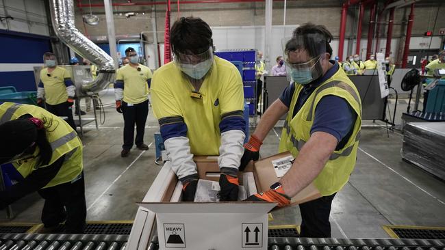 Workers pack boxes containing the Pfizer-BioNTech COVID-19 vaccine at the Pfizer manufacturing plant in Kalamazoo, Michigan. Picture: AFP