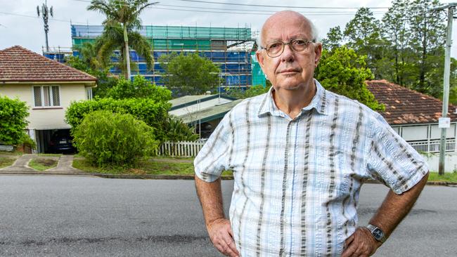 Indooroopilly resident Michael Yeates in front of a proposed development in Rylatt St. Picture: AAP/Richard Walker