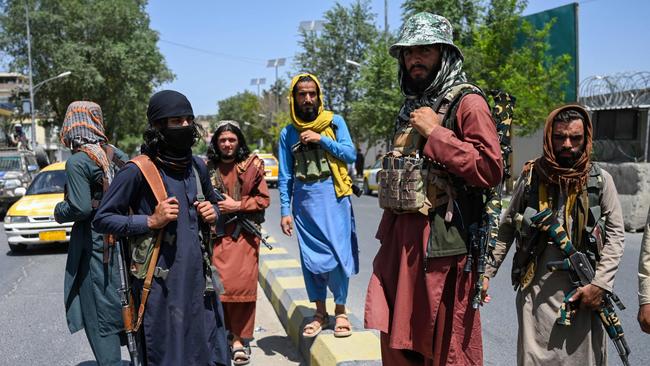 Taliban fighters stand guard along a street in Kabul. Picture: AFP