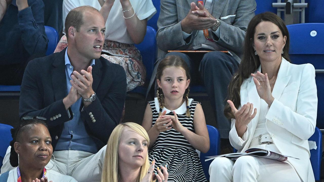 Britain's Prince William, Duke of Cambridge (L) and Britain's Catherine, Duchess of Cambridge (R) sit with their daughter Britain's Princess Charlotte of Cambridge (C) as they watch the men's 1500m freestyle heats. (Photo by Oli SCARFF / AFP)