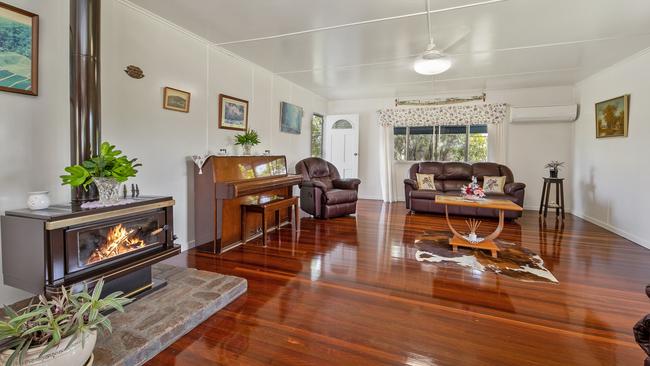 The property boasted a three-bedroom, two bathroom farmhouse with timber flooring and a country style kitchen opening into lounge. Picture: Contributed