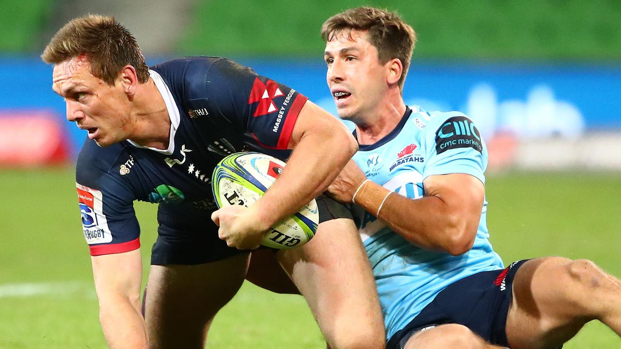 Dane Haylett-Petty of the Rebels is tackled by Jake Gordon of the Waratahs.