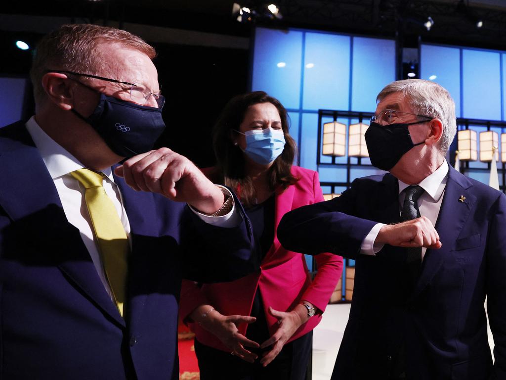 John Coates (left) has told the Queensland Premier she ‘will be going’ to the opening ceremony in Tokyo on Friday despite her earlier protestations that she would not attend. Picture: Toru Hanai / AFP