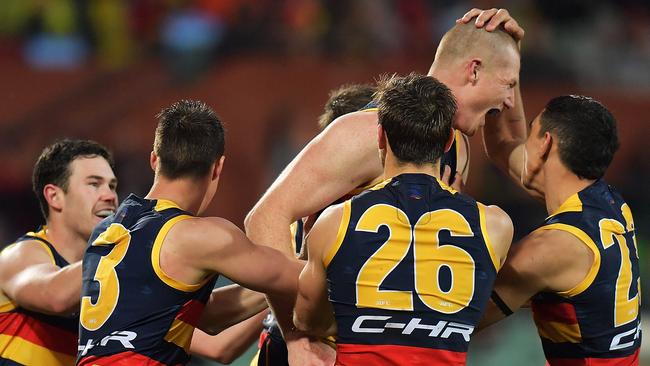 Adelaide celebrates victory over rivals Port Adelaide.