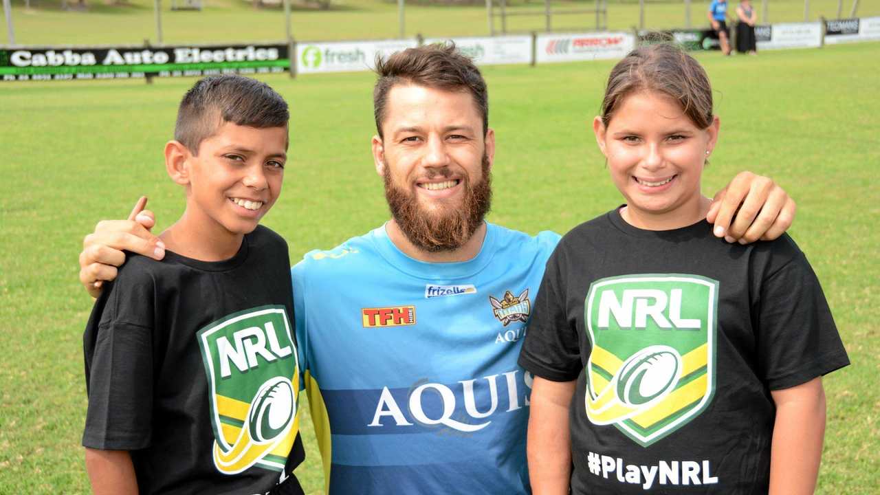 Titans' player Matt Robinson with Tweed twins Jyungarah Pearce, 11 and Kiala Pearce, 11 at the Titans' NRL School Holiday Footy Clinic at Cudgen Fields on Tuesday, April 19. Picture: Daniel McKenzie