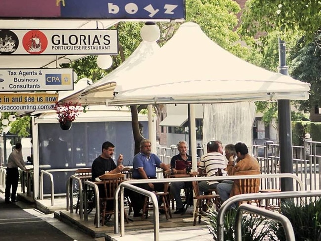 Regulars sitting outside Gloria’s Cafe in Petersham.