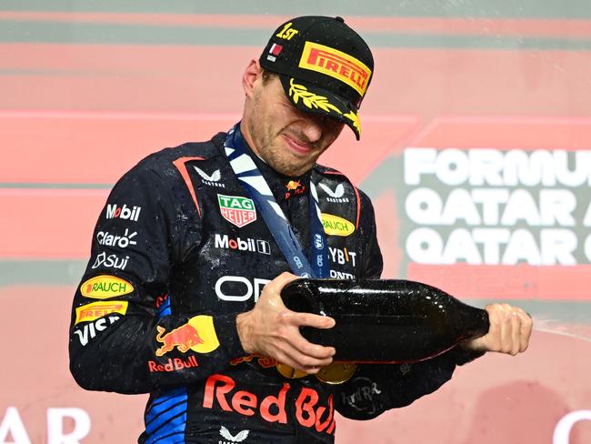 LUSAIL CITY, QATAR - DECEMBER 01: Race winner Max Verstappen of the Netherlands and Oracle Red Bull Racing celebrates on the podium during the F1 Grand Prix of Qatar at Lusail International Circuit on December 01, 2024 in Lusail City, Qatar. (Photo by Clive Mason/Getty Images)