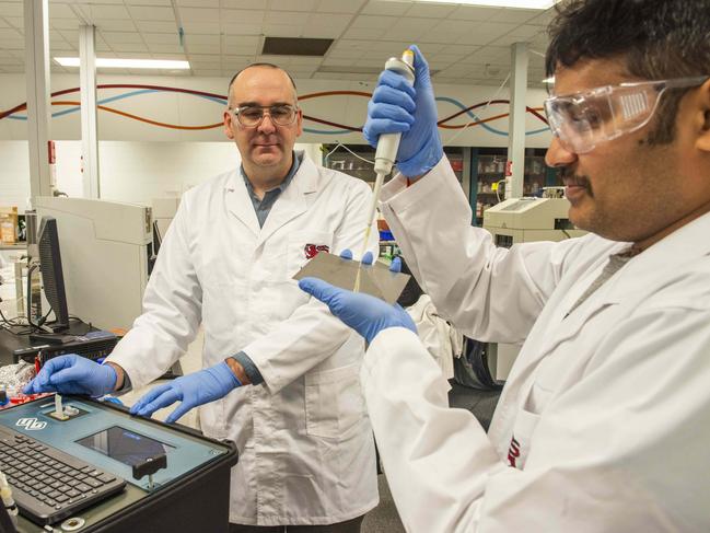 Michael Breadmore, left, and Pavan Kumar Chadalawada test for flu using adapted explosives detection technology Picture: Chris Crerar.