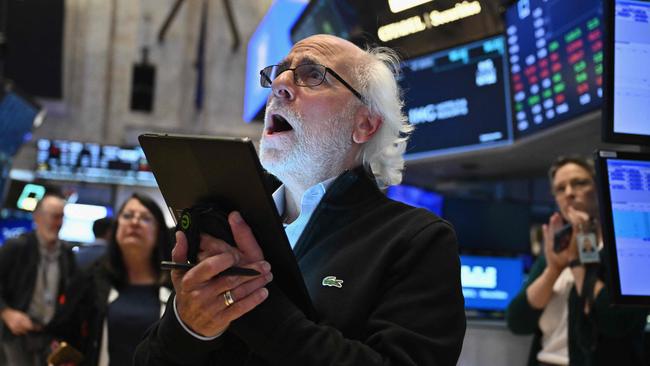 Traders work on the floor of the New York Stock Exchange. (Photo by ANGELA WEISS / AFP)