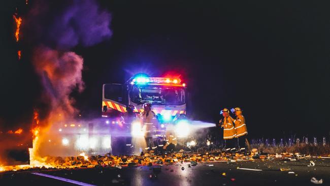 The Pacific Motorway was littered with exploding spray paint cans as firefighters work to bring the blaze under control. Picture: Jackson Whitney