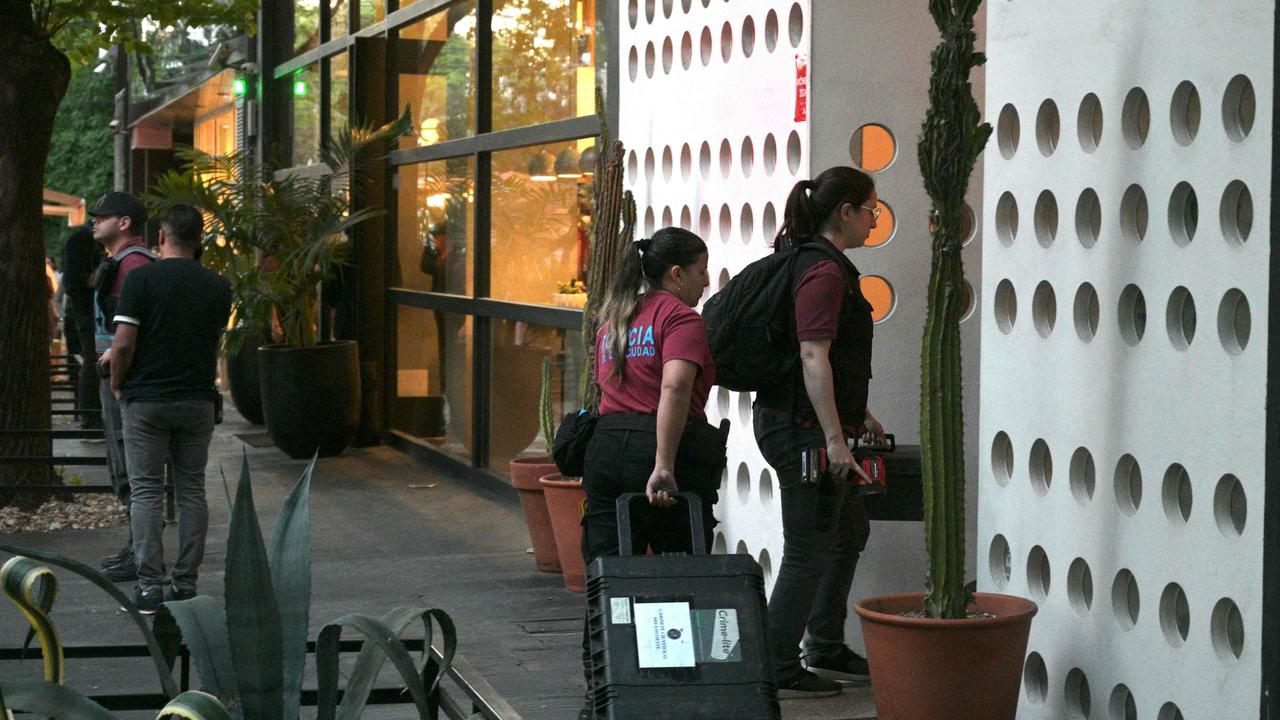 Forensic police arrive at CasaSur to examine the scene. Picture: Juan Mabromata/AFP