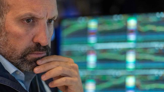 A US trader works on the floor of the New York Stock Exchange as the Nasdaq hits a technical correction. Picture: Getty Images