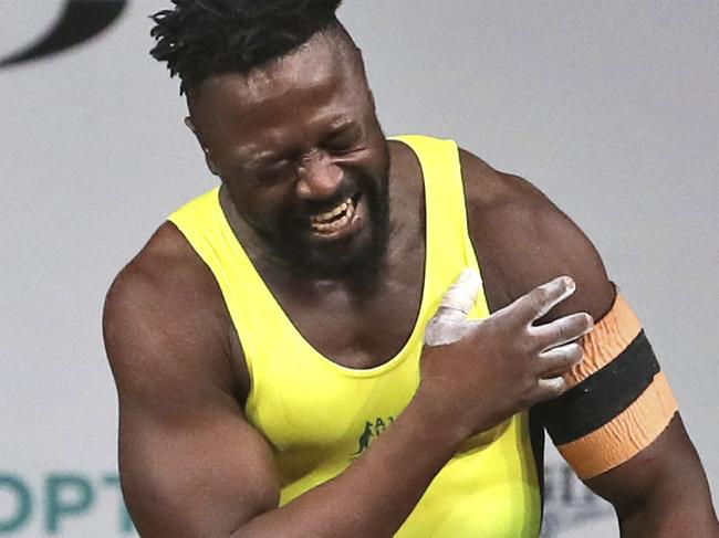 Australia's Francois Etoundi reacts in pain in his left shoulder after a lift in the Men 77kg Weightlifting final during the Commonwealth Games, in Gold Coast, Australia, Saturday, April 7, 2018. Etoundi won Bronze medal in his category. (AP Photo/Manish Swarup)