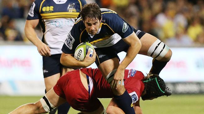 CANBERRA, AUSTRALIA - FEBRUARY 13: Sam Carter of the Brumbies is tackled during the round one Super Rugby match between the Brumbies and the Reds at GIO Stadium on February 13, 2015 in Canberra, Australia. (Photo by Stefan Postles/Getty Images)