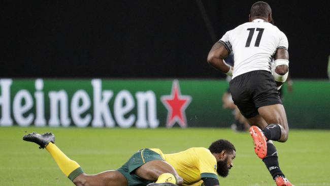 Fiji's Semi Radradra runs past Australia's Marika Koroibete. Picture: AP