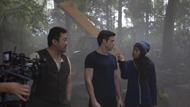 Lee, Richard Madden and director Chloe Zhao behind the scenes on Eternals. Picture: Marvel Studios